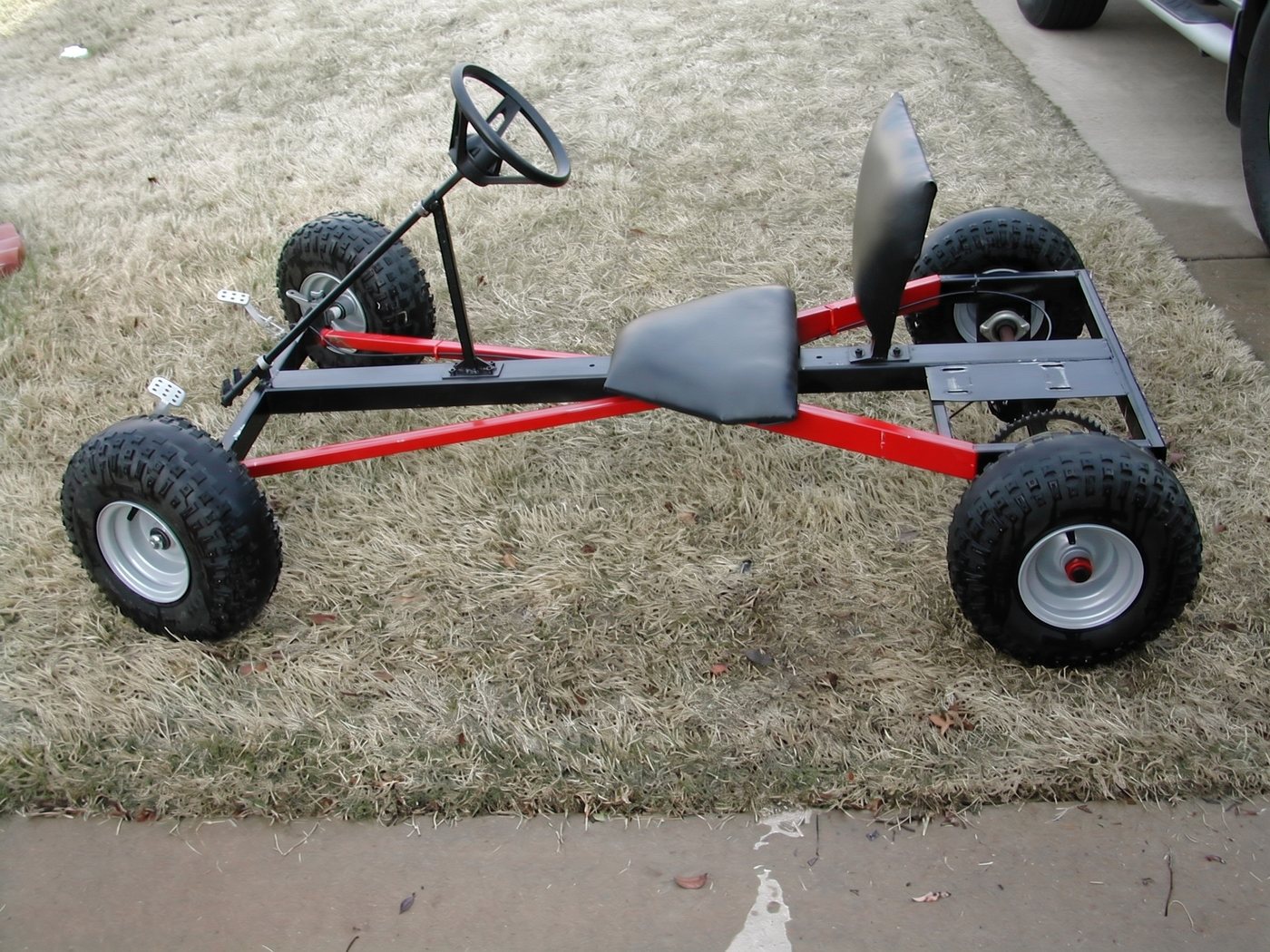 Black Widow red X-frame, three-quarter on grass