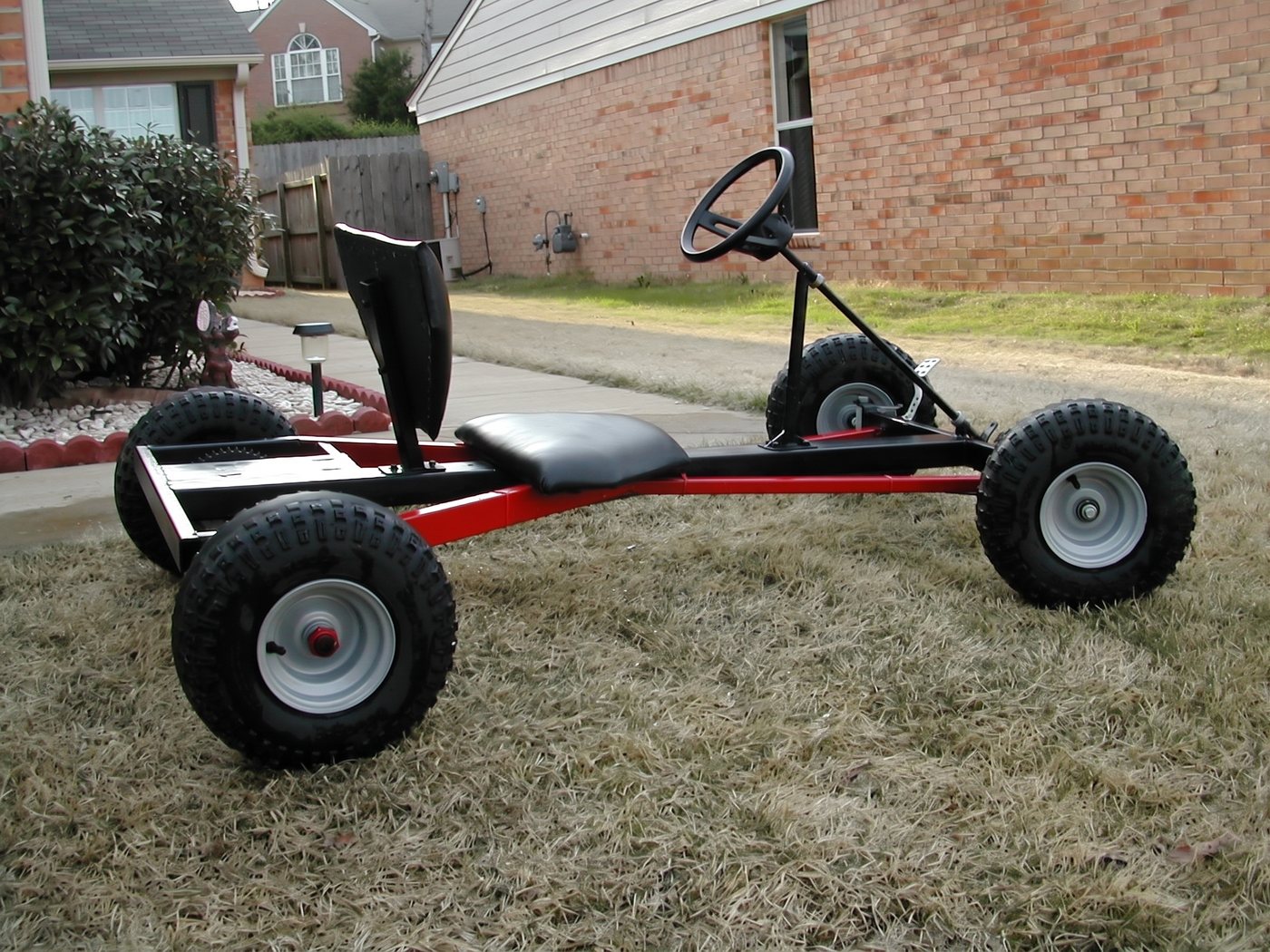 Black Widow red frame, side on grass